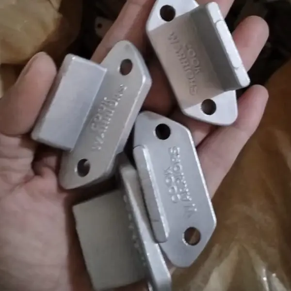 Cook Warriors-branded stainless steel mounting brackets — the smart bolt-on system that turns a frying pan into the Eggscalibur sword pan