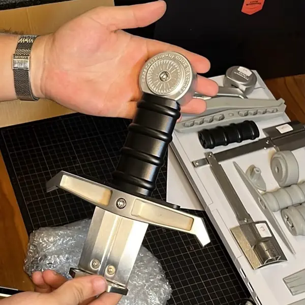 Cook Warriors Eggscalibur stainless steel sword pan unboxing — premium kitchen gift with engraved pommel medallion